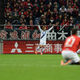 Mitsubishi Motors sponsorship sign behind Gamba Osaka defender Hiroki Fujiharu as he reacts after scoring the extra time game winner in his team’s 3-1 victory over Urawa Reds in the 2015 J.League Playoff Semifinal. Saitama, Japan. Image Credit: Dan Orlowitz/Football Channel